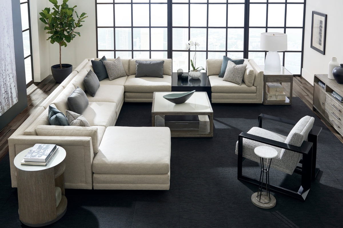Modern living room with a sectional sofa, coffee table, and decorative items.