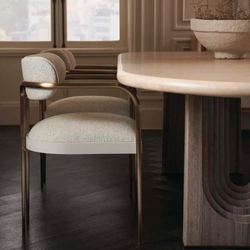 Organic-shaped dining table in natural stone finish reflecting quiet luxury style with earthy tones and timeless craftsmanship