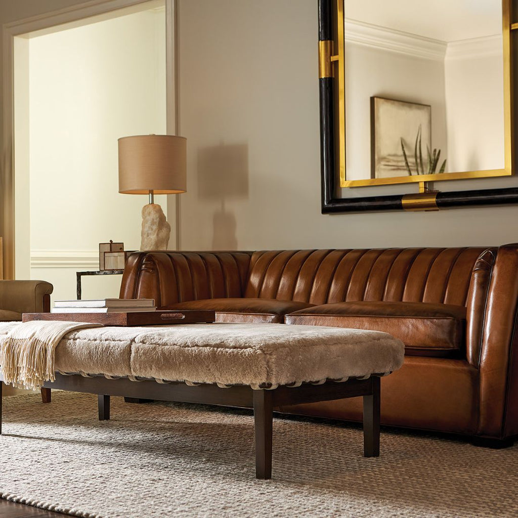 Channel back leather sofa in full grain co hide with suede ottoman.