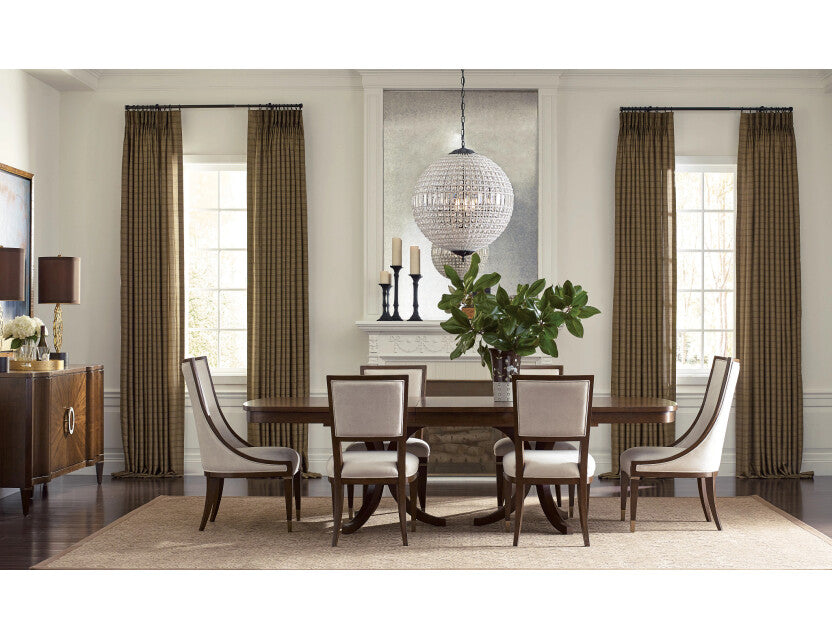 Traditional dining room with round pedestal table, cream upholstered chairs, and crystal globe chandelier