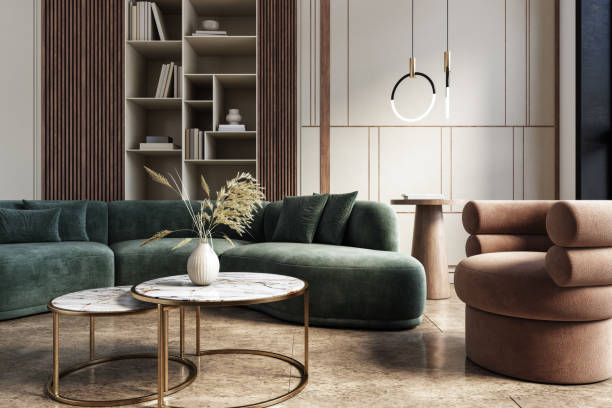 Luxury modern living room with emerald green velvet sectional sofa, marble and gold coffee tables, terracotta bouclé armchair, and wood slat bookshelf with pendant lighting.