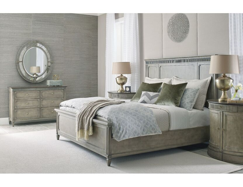 Grey wood panel bed with dentil moulding headboard and matching six-drawer dresser with round mosaic mirror in transitional grey bedroom set