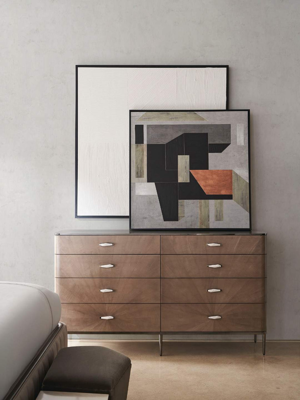 Contemporary wooden dresser with abstract art on a gray wall