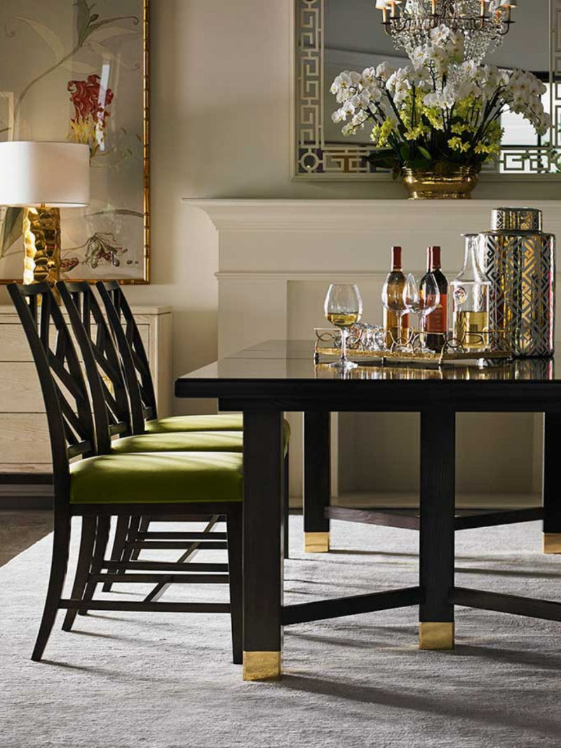 Chinoiserie inspired dining set with  moss coloured green velvet seats on the dark brown wood chairs.