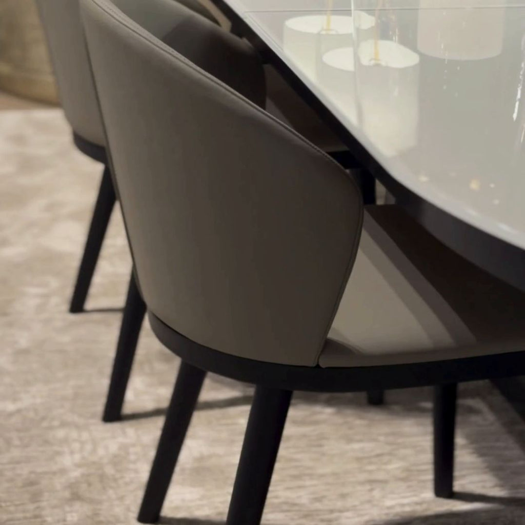 Contemporary Dining Chaire in grey leather with black wood base.