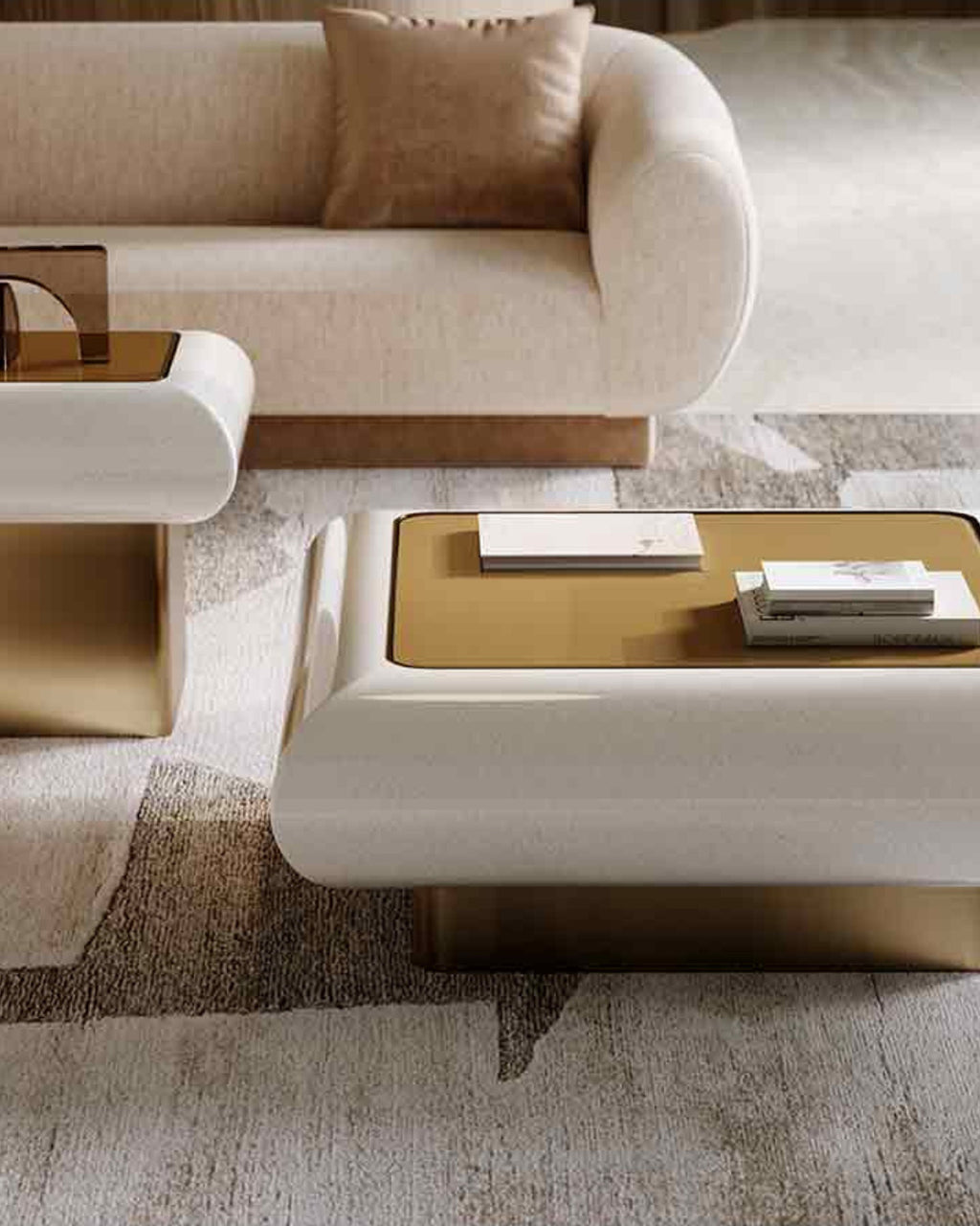 A modern low coffee table with a cream-colored curved frame, a gold rectangular top, and a gold pedestal base, styled in a contemporary living room setting.