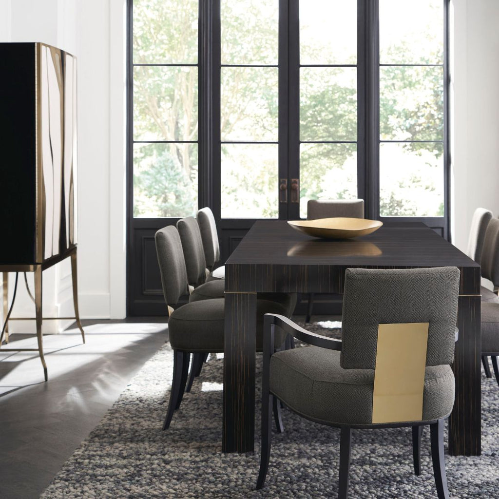 Modern dining room with a dark wooden table and gray chairs.