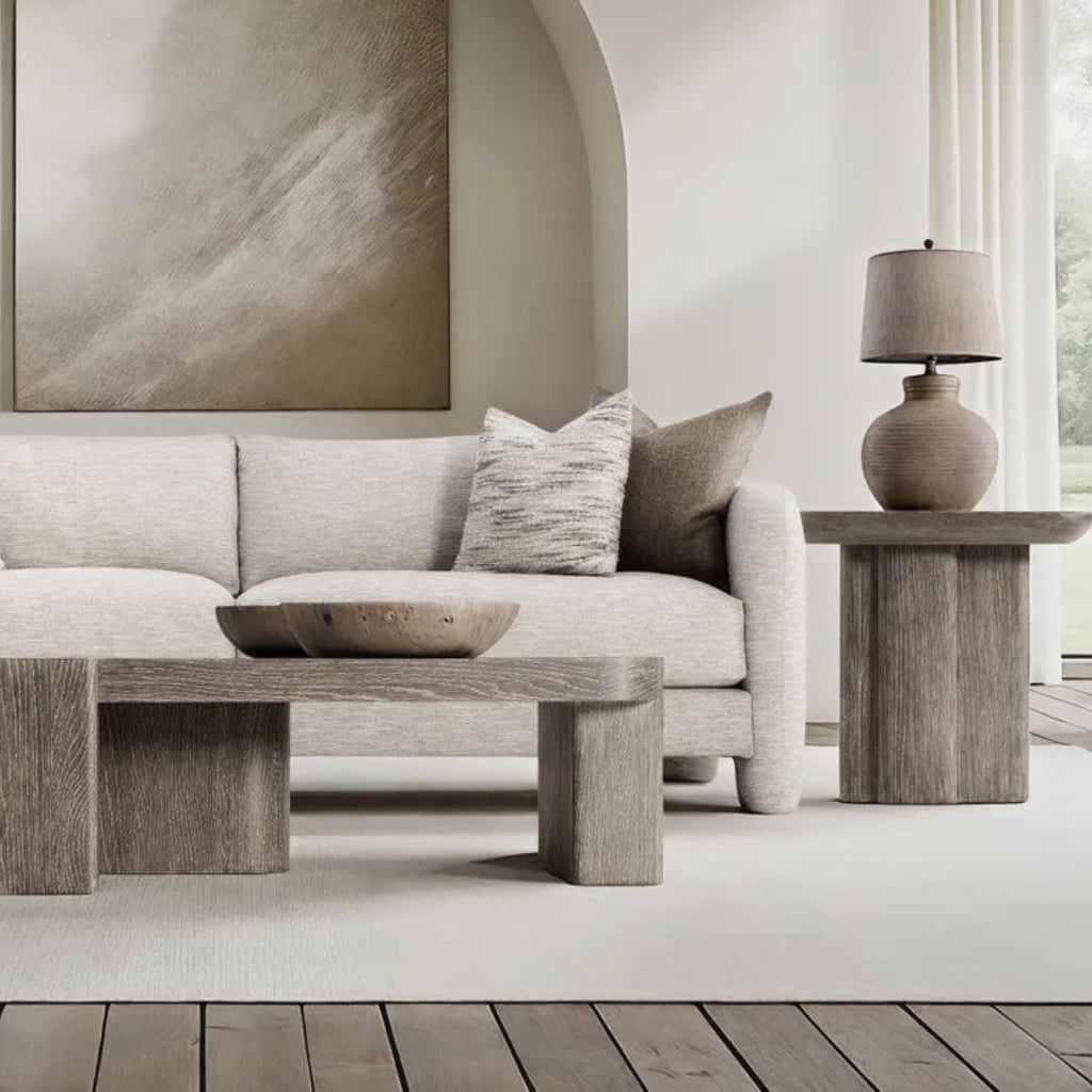 Modern living room with neutral fabric and rustic flooring.
