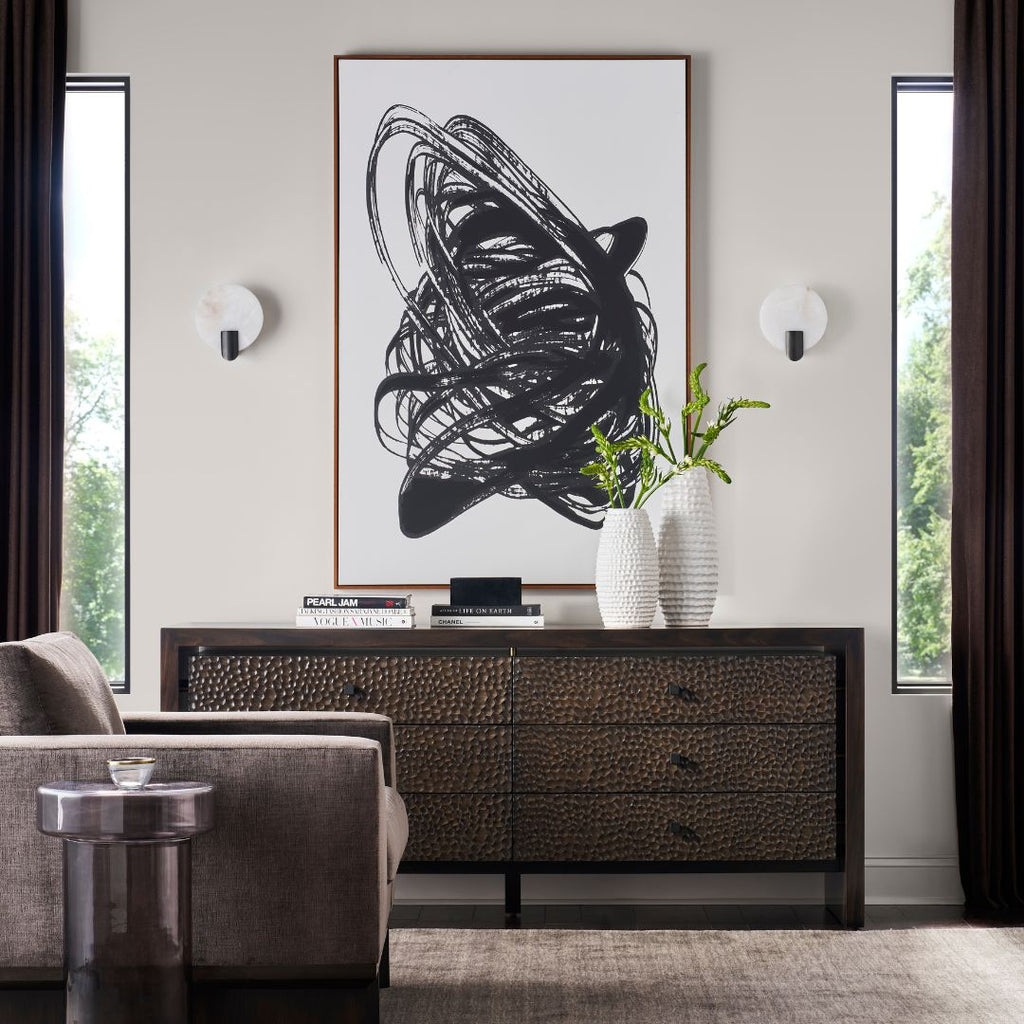 Modern living room with a large abstract black and white painting on the wall.