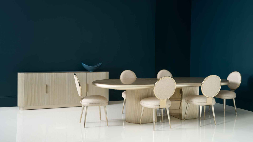 Dining room setup with a table and chairs against a dark blue wall.