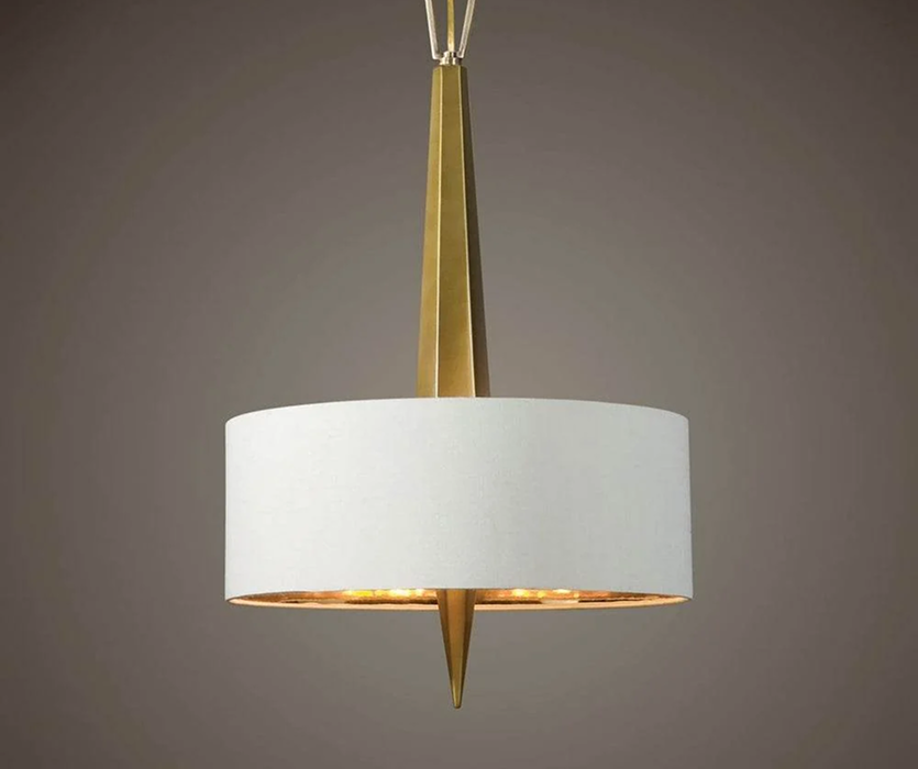 A white drum pendant light with a tapered brass stem and gold accent, suspended from a slim rod