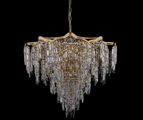 A gold chandelier with layered tiers of hanging crystal drops on a black background