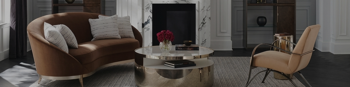 Curved caramel leather armchair with a rounded back in a warmly lit living room with deep brown tones and a softly shadowed wall 