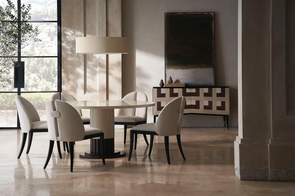 Contemporary dining room with a round table and chairs in a chic modern interior setting.