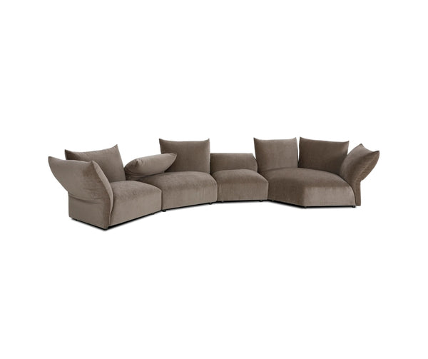 Curved modular sectional sofa in taupe fabric with plush cushions and a low-profile design, shown on a white background.